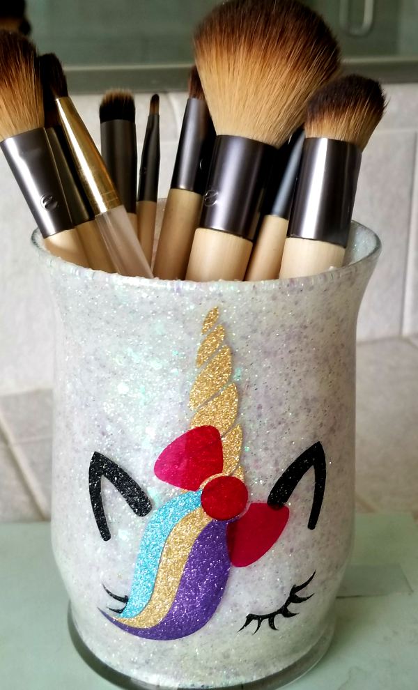 White and pink glitter brush holders with a star and a heart on them.